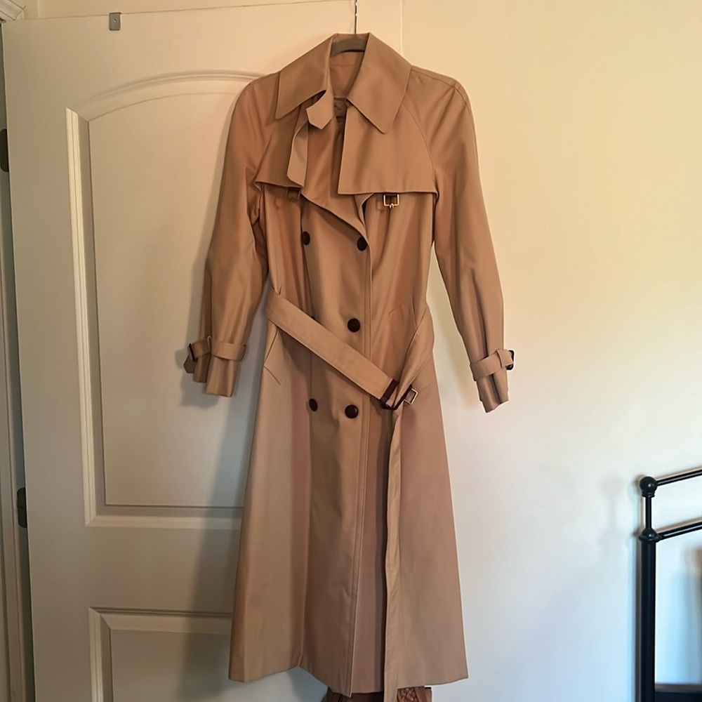 Trench Coat, tan with dark brown trim. Brass hardware. Double-breasted, classic
